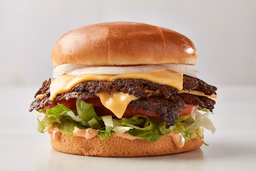 Freddy's menu spicy burger featuring two beef patties, pepper jack cheese, jalapeños, and sauce on a toasted bun.